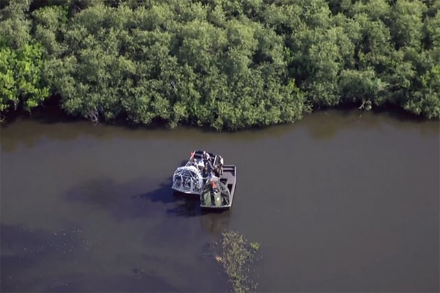 Authorities investigate a fatal alligator attack on a kayaker on Lake Kissimmee, in Osceola County, Fla., on Tuesday.