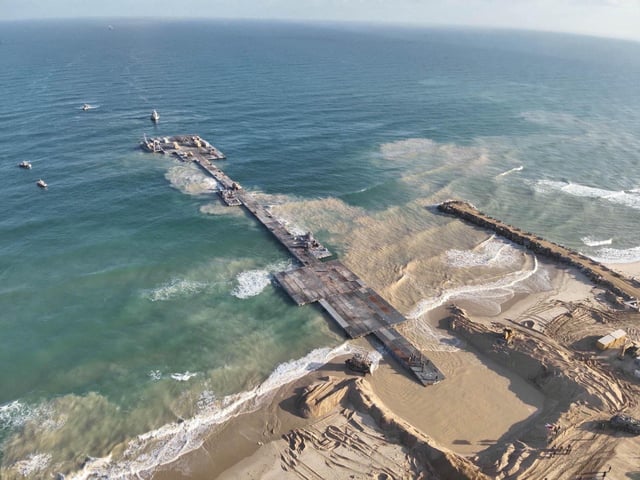 Ships are seen near a temporary floating pier built to receive humanitarian aid in the Gaza Strip in Gaza Beach, in this handout picture obtained by Reuters on May 18, 2024. Israel Defense Forces/Handout via REUTERS/File Photo