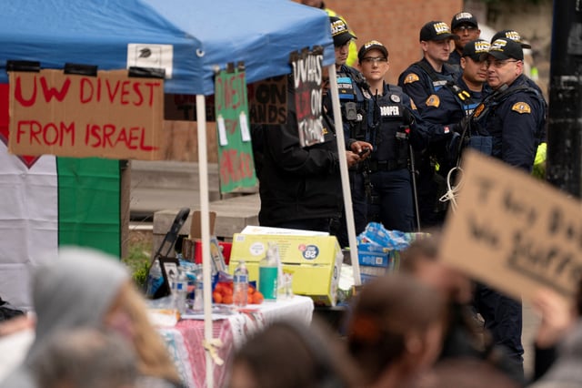 Washington State Patrol Troopers watch as demonstrators gather to protest in support of causes that include the Palestinians, immigration, labor, and the environment, at the University of Washington in Seattle, Washington, U.S., March 12, 2025. REUTERS/David Ryder/File Photo