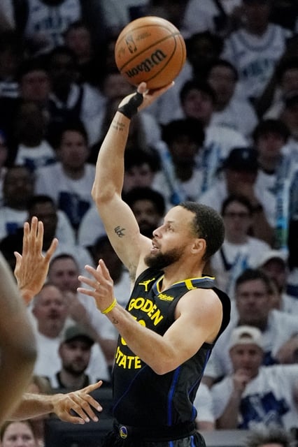 May 6, 2025; Minneapolis, Minnesota, USA; Golden State Warriors guard Stephen Curry (30) shoots against the Minnesota Timberwolves in the first quarter during game one of the second round for the 2025 NBA Playoffs at Target Center. Mandatory Credit: Bruce Kluckhohn-Imagn Images