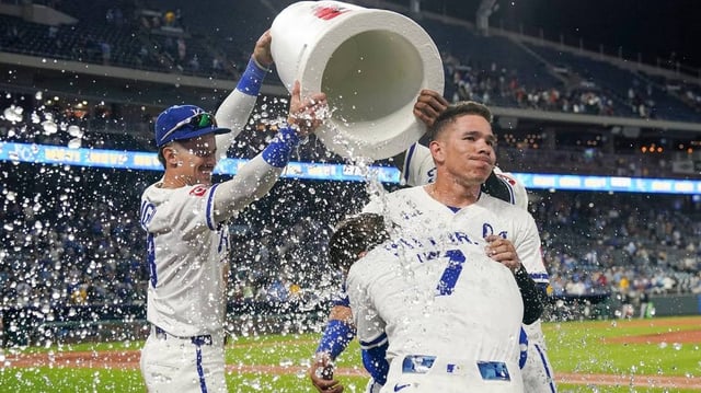 May 6, 2025; Kansas City, Missouri, USA; Kansas City Royals shortstop Bobby Witt Jr. (7) and catcher Freddy Fermin (34) are doused by right fielder Cavan Biggio (18) and designated hitter Salvador Perez (13) after the win over the Chicago White Sox at Kauffman Stadium. Mandatory Credit: Denny Medley-Imagn Images