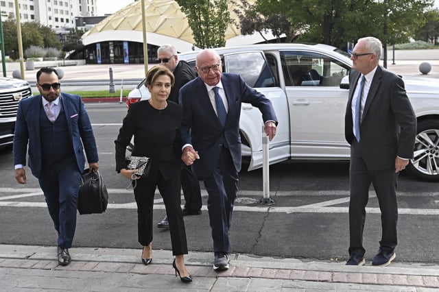 FILE - Rupert Murdoch, center, and his wife Elena Zhukova Murdoch arrive at the Second Judicial District Court in Reno, Nev., Monday Sept. 16, 2024. (AP Photo/Andy Barron, File)