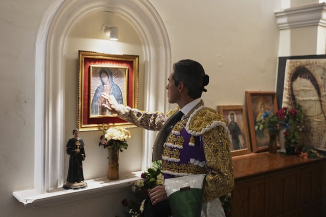 Mexican bullfighter Diego Silveti touches an image of the Virgin of Guadalupe in the bullring chapel before a bullfight in Aguascalientes, Mexico, Sunday, April 27, 2025. (AP Photo/Eduardo Verdugo)