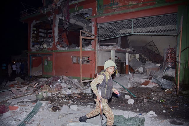 An army soldier examines a building damaged by an Indian missile strike near Muzaffarabad, Pakistan-administered Kashmir, on Wednesday, May 7, 2025.