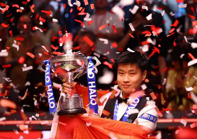 Snooker - World Snooker Championship - The Crucible Theatre, Sheffield, Britain - May 5, 2025 China's Xintong Zhao celebrates with the trophy after winning his final match against Wales' Mark Williams Action Images via Reuters/Andrew Boyers/File Photo