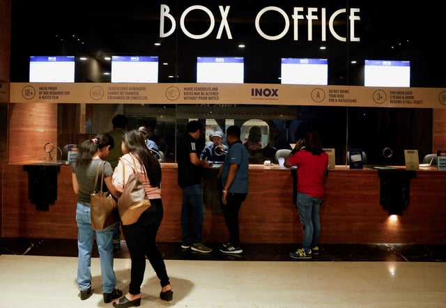 People wait in queue to purchase movie tickets at an INOX multiplex cinema hall inside a shopping mall in Kolkata, India, February 22, 2024. REUTERS/Sahiba Chawdhary/File Photo