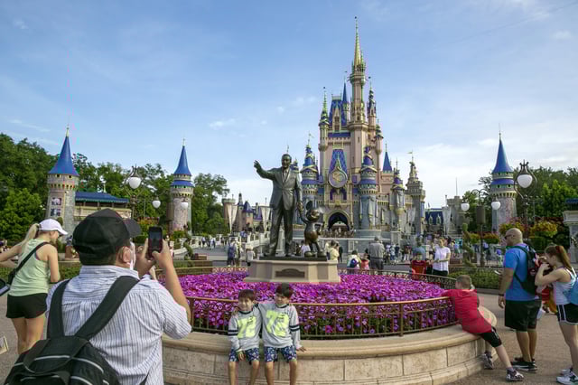FILE - People visit the Magic Kingdom Park at Walt Disney World Resort in Lake Buena Vista, Fla., April 18, 2022. (AP Photo/Ted Shaffrey, File)