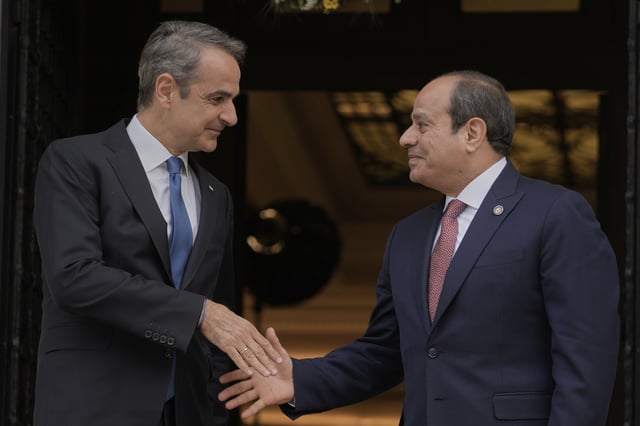 Greece's Prime Minister Kyriakos Mitsotakis, left, welcomes Egyptian President Abdel-Fattah el-Sissi prior their meeting in Athens, on Wednesday, May 7, 2025. (AP Photo/Petros Giannakouris)