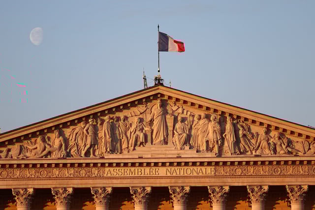 A French flag flies over the National Assembly in Paris, France, April 18, 2025. REUTERS/Abdul Saboor