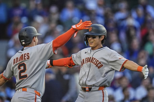 San Francisco Giants' Jung Hoo Lee (51), right, hugs Willy Adames (2) after Lee hit a two-run home run during the third inning of a baseball game against the Chicago Cubs, Tuesday, May 6, 2025, in Chicago. (AP Photo/Erin Hooley)