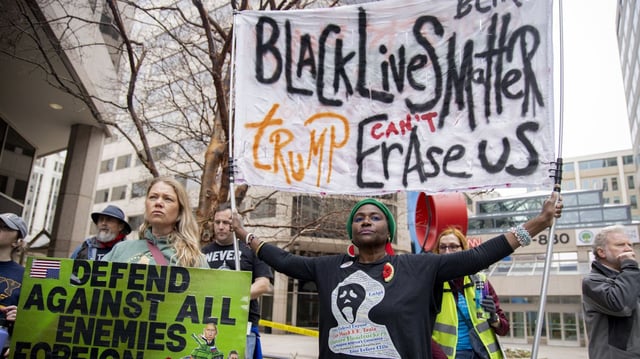A protester raises a large banner reading "Black Lives Matter, Trump Can't Erase Us" among others during the "Media March" in Washington, D.C. on March 15, 2025. Photo: Hanna Leka/Middle East Images/AFP via Getty Images