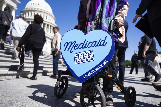 A Medicaid sign is seen as House Minority Leader Hakeem Jeffries, D-N.Y., and Sen. Cory Booker, D-N.J., conduct a live-streamed conversation with Americans on the House steps of the U.S. Capitol on Sunday, April 27, 2025. (Tom Williams/CQ Roll Call via AP Images)