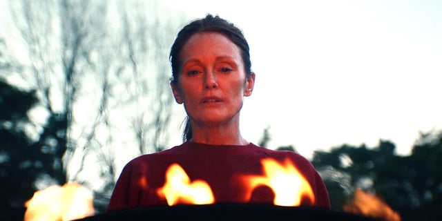 Julianne Moore in Echo Valley standing over a fire
