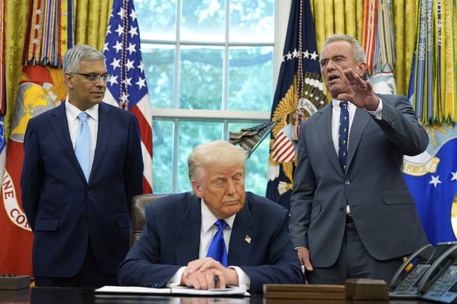 President Donald Trump listens as Health and Human Services Secretary Robert F. Kennedy Jr., speaks as he signs executive orders and proclamations in the Oval Office of the White House, Monday, May 5, 2025, in Washington. Jay Bhattacharya, director of the National Institutes of Health, listens at left.