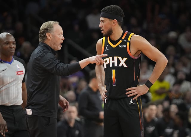 Phoenix Suns head coach Mike Budenholzer talks with guard Devin Booker during NBA Cup group play against the San Antonio Spurs at Footprint Center on Dec. 3, 2024.