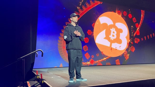 Jack Mallers, founder and CEO of Strike, stands on a stage at Bitcoin 2023. (Frederick Munawa)