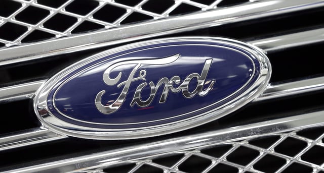 FILE - In this Jan. 5, 2015, file photo, the Ford logo shines on the front grille of a 2014 Ford F-150, on display at a local dealership in Hialeah, Fla. Ford will build a new $1.6 billion factory in Mexico, creating about 2,800 jobs and shifting small-car production from the U.S. The announcement Tuesday, April 5, 2016 comes at a time when moving jobs to the south has become a major issue in the U.S. presidential campaign. 
