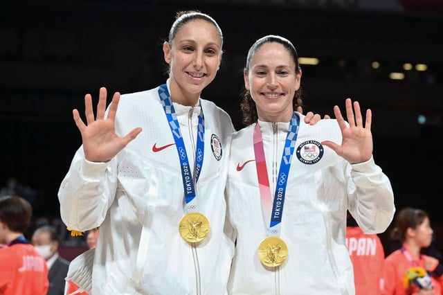 UConn legends Sue Bird, right, and Diana Taurasi tell the world just how many gold medals they&#39;ve won together following Team USA&#39;s championship performance in Tokyo in 2021. (Getty Images)