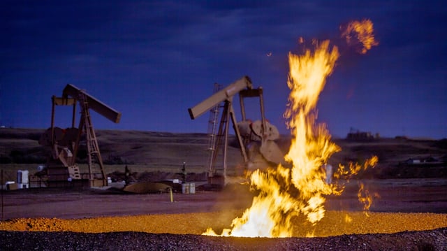 Flames from a flaring pit near a well in the Bakken Oil Field.