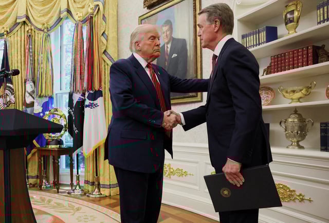 U.S. President Donald Trump shakes hands with former U.S. Senator David Perdue during Perdue's swearing-in ceremony to be the new U.S. ambassador to China, at the White House in Washington, D.C., U.S., May 7, 2025. REUTERS/Leah Millis/File Photo