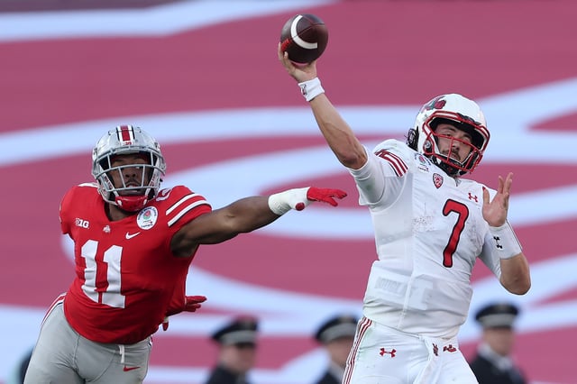 PASADENA, CALIFORNIA - JANUARY 01: Cameron Rising #7 of the Utah Utes throws a pass as Tyreke Smith #11 of the Ohio State Buckeyes pressures him during the first half in the Rose Bowl Game at Rose Bowl Stadium on January 01, 2022 in Pasadena, California.