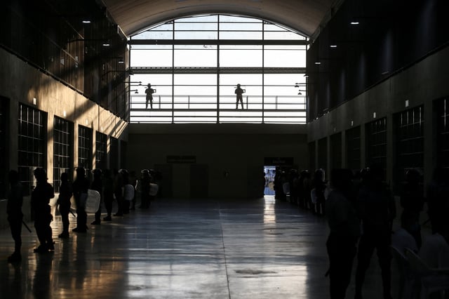 Police officers stand guard at the Terrorism Confinement Center (CECOT) prison, during a media tour, in Tecoluca, El Salvador April 4, 2025. REUTERS/Jose Cabezas/File Photo