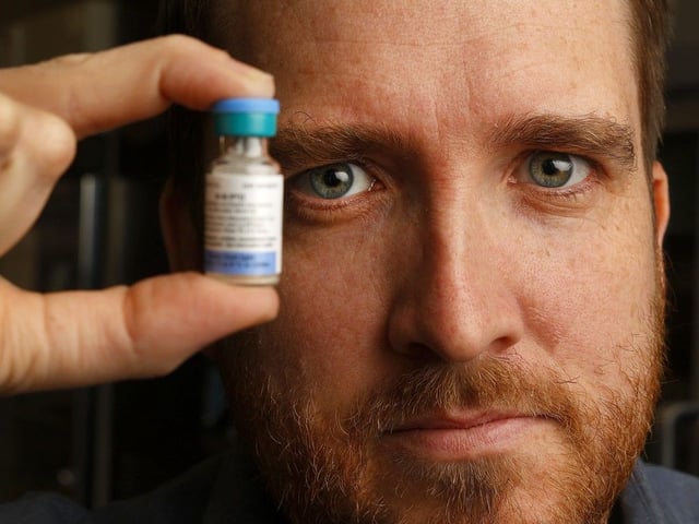 Dr. Trevor Arnason, Ottawa's interim medical officer of health, displays a vial of measles vaccine.