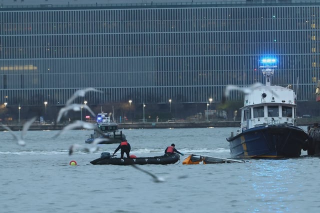 Crews work to remove a crashed helicopter from the Hudson River on April 10, 2025.