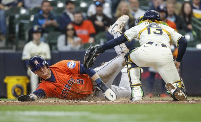 Houston Astros&#39; Zach Dezenzo slides safety into home plate ahead of the tag by Milwaukee Brewers&#39; Eric Haase (13) during the fifth inning of a baseball game, Wednesday, May 7, 2025, in Milwaukee. (AP Photo/Jeffrey Phelps)