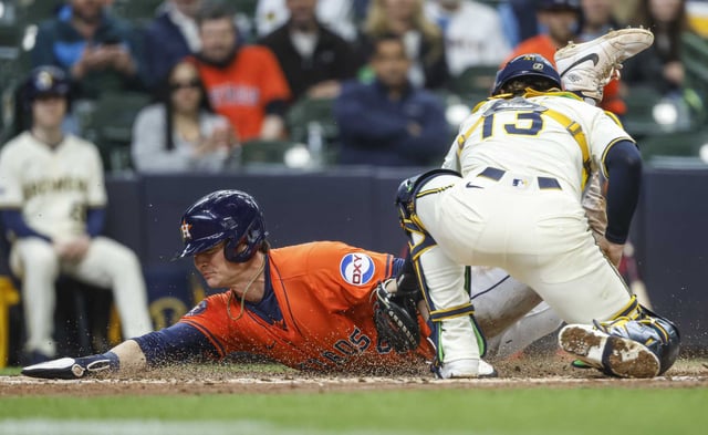 Houston Astros&#39; Zach Dezenzo slides safety into home plate ahead of the tag by Milwaukee Brewers&#39; Eric Haase (13) during the fifth inning of a baseball game, Wednesday, May 7, 2025, in Milwaukee. (AP Photo/Jeffrey Phelps)