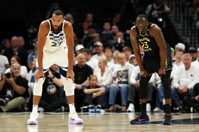 Rudy Gobert of the Minnesota Timberwolves and Draymond Green of the Golden State Warriors ready for play in the first quarter of Game 1 of the second round of the 2025 NBA playoffs at Target Center on May 6, 2025, in Minneapolis.