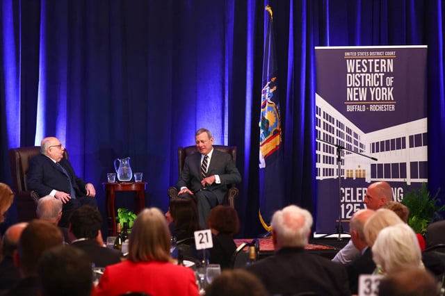 Chief Justice John Roberts, right, speaks with U.S. District Judge Lawrence J. Vilardo during a fireside chat at the 125th anniversary celebration of the United States District court for the Western District of New York, Wednesday, May 7, 2025, in Buffalo, N.Y. (AP Photo/Jeffrey T. Barnes