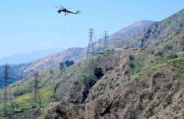 On Wednesday, May 7,2025, Southern California Edison crews air lifted out the top half of the transmission line suspected of sparking the Eaton fire. The tower, 208, is being removed in order to be preserved as evidence.  (Photo by Dean Musgrove, Los Angeles Daily News/SCNG)