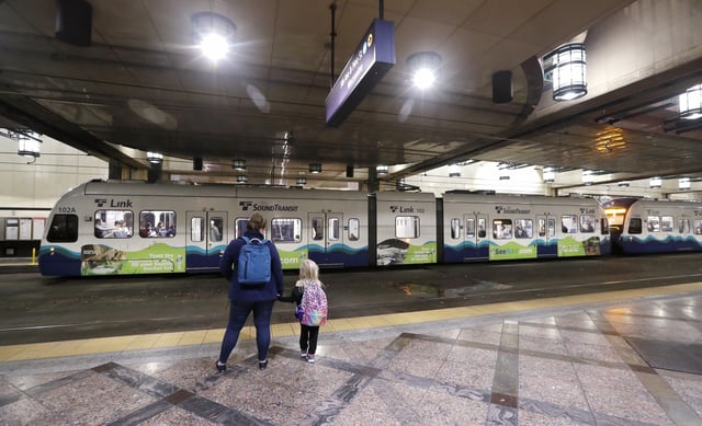 FILE - Southbound passengers wait as they look across at a northbound Sound Transit light rail train at an underground station in downtown Seattle, Nov. 6, 2019. (AP Photo/Elaine Thompson, File)