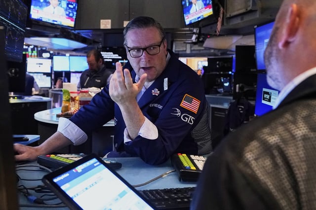 Specialist Gregg Maloney, left, works on the floor of the New York Stock Exchange, Wednesday, May 7, 2025. (AP Photo/Richard Drew)