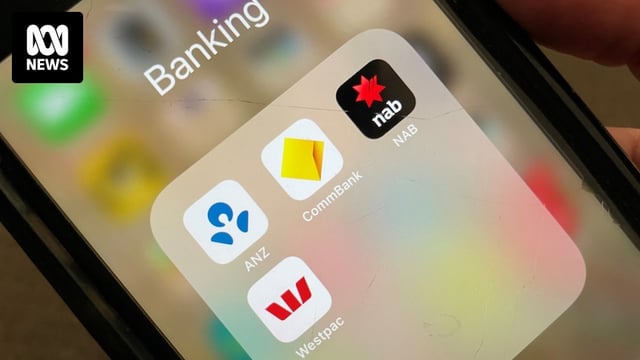 A person holds an iPhone with the banking apps for ANZ, Commonwealth Bank, NAB and Westpac open.