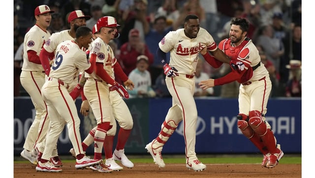 Teammates swarm the Angels’ Jorge Soler, second from right, after he hit a three-run, walk-off double in the ninth inning to give them a 5-4 victory over the Toronto Blue Jays on Wednesday night at Angel Stadium. (AP Photo/Mark J. Terrill)