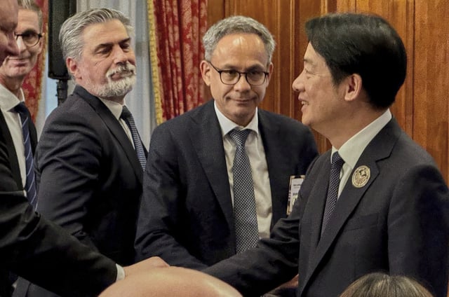 Taiwan's President Lai Ching-te, right, shakes hands with representatives from European trade offices after delivering a speech at the 80th Anniversary Commemoration Ceremony of Victory in Europe at Taipei Guest House, in Taipei, Thursday, May 8, 2025. (AP Photo/Johnson Lai)