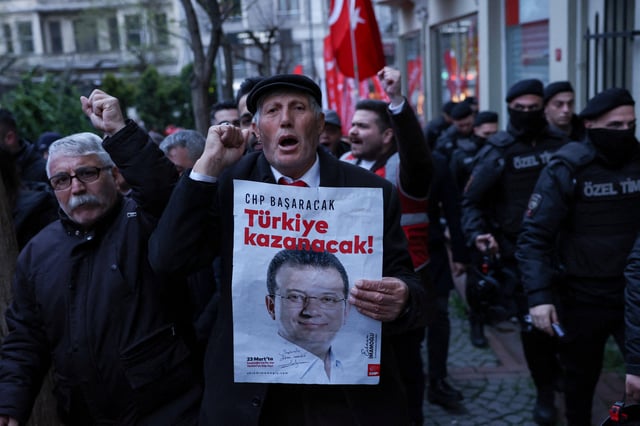 A man holds a poster with a picture of Istanbul Mayor Ekrem Imamoglu during a rally to protest against the arrest of Imamoglu as part of a corruption investigation, in Istanbul, Turkey, April 9, 2025. REUTERS/Dilara Senkaya/File Photo