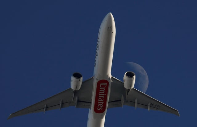 An Emirates Boeing 777-31H(ER) flies in front of the moon after taking off from Malta International Airport bound for Larnaca in Cyprus, seen from Ta' Qali, Malta, January 5, 2025. REUTERS/Darrin Zammit Lupi/File Photo