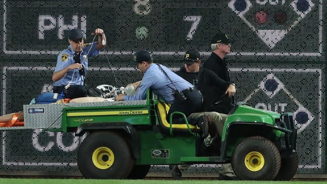 Stadium security and Pittsburgh Pirates medical personnel cart Kavan Markwood, who fell from the stands to the field to an ambulance 