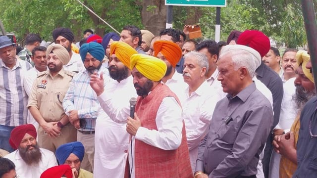 Punjab chief minister Bhagwant Mann addressing Aam Aadmi Party workers, while state education minister Harjot Singh Bains looks on after locking the the Nangal dam guest house gate during BBMB chairman Manoj Tripathi’s visit on Thursday. (HT Photo)