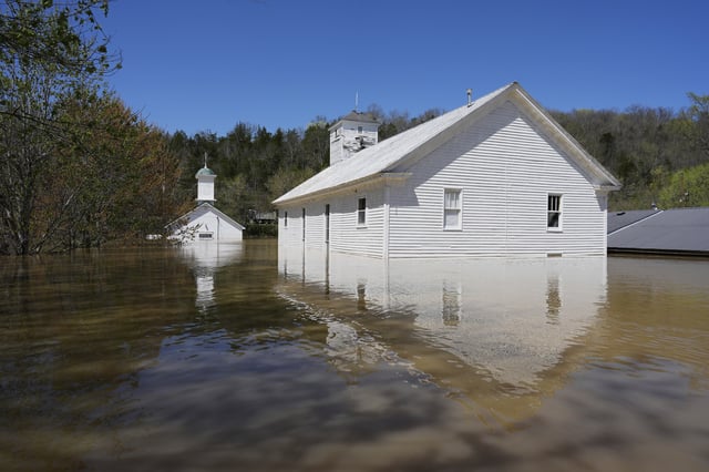 FILE - Two churches, one Catholic and one Baptist are flooded by the Kentucky River in Lockport, Ky., Tuesday, April 8, 2025. (AP Photo/Carolyn Kaster, File)