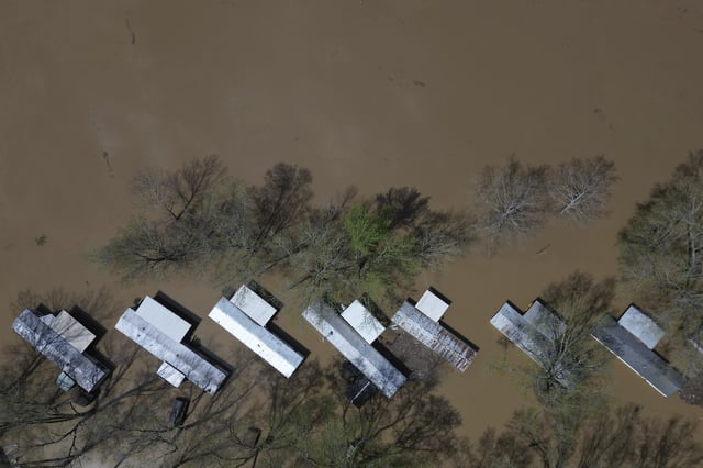 FILE - A mobile home park floods where rising waters of the Little Sugar Creek meet the Ohio River, Monday, April 7, 2025, in Napoleon, Ky. (AP Photo/Carolyn Kaster, File)