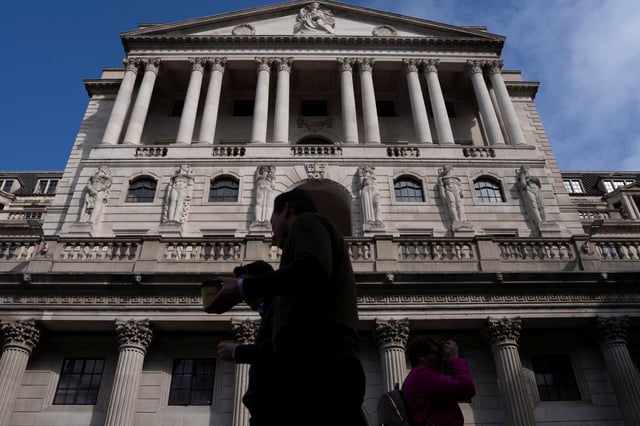 People walk outside the Bank of England building in London, Britain, May 8, 2025. REUTERS/Carlos Jasso/File photo