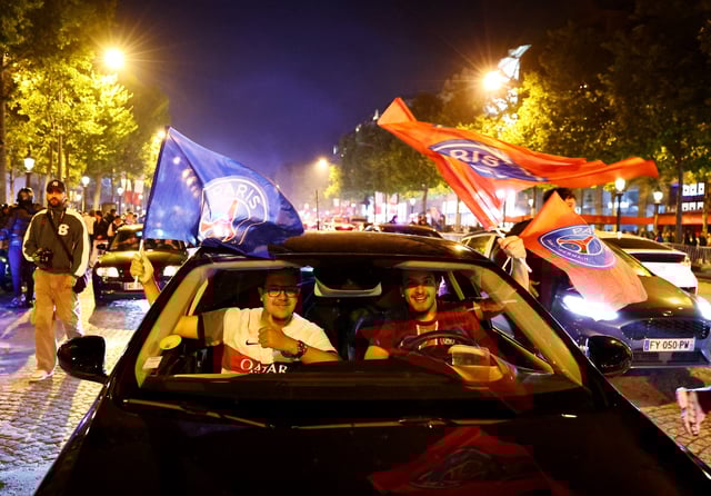 Soccer Football - Champions League - Fans celebrate after Paris St Germain qualifies for the final - Paris, France - May 7, 2025 Paris St Germain fans celebrate after reaching the final near the Champs Elysees avenue REUTERS/Abdul Saboor