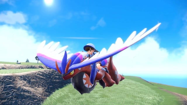A player gliding through the region of Paldea on the back of the Legendary Pokémon Koraidon in Pokémon Scarlet.