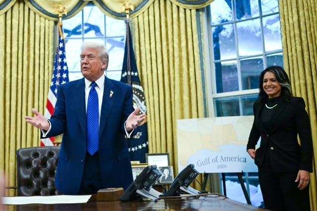 US President Donald Trump and newly sworn in Director of National Intelligence Tulsi Gabbard address reporters in the Oval Office, in front of a map identifying the "Gulf of America"