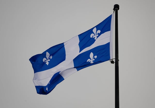 The Quebec Fleur-de-lis provincial flag flies on top of the National Assembly’s main tower, Wednesday, January 18, 2023 in Quebec City. The Fleur-de-lis will celebrate its 75th anniversary on Saturday. THE CANADIAN PRESS/Jacques Boissinot