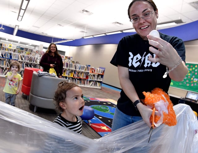 Eva Johnston, 3, marvels as Alyssa Crow pulls her egg from its wrapping, unharmed. Crow is the manager of the south branch of the Abilene Public Library which held an Egg Drop Challenge on April 17, 2021.
